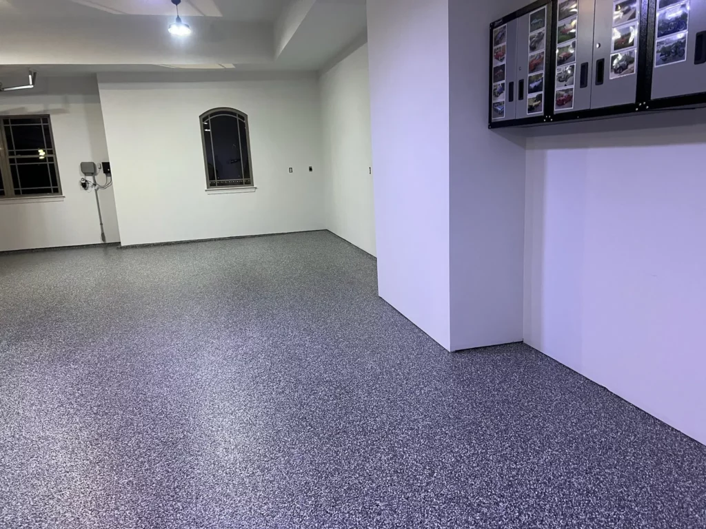 A custom epoxy garage floor in Kirkwood, Missouri, with a sleek and speckled finish.