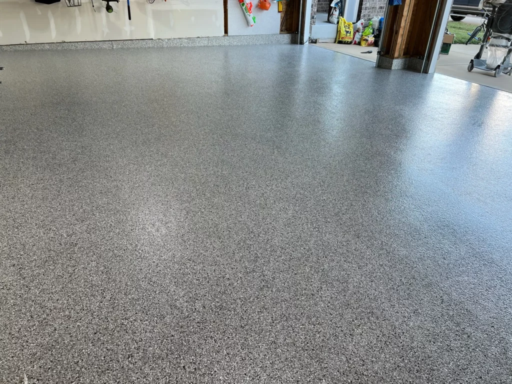 A smooth and glossy epoxy garage floor in Wildwood, Missouri, reflecting natural light.