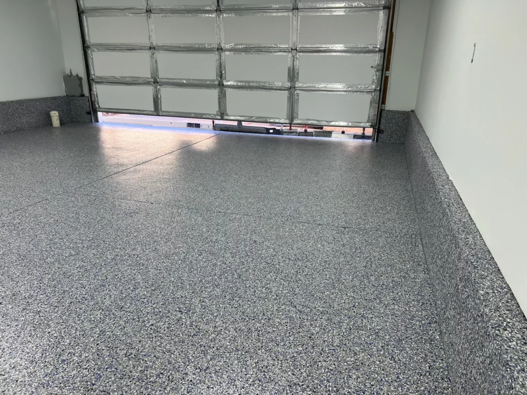 A seamless epoxy garage floor in Lake St. Louis with a cove base.