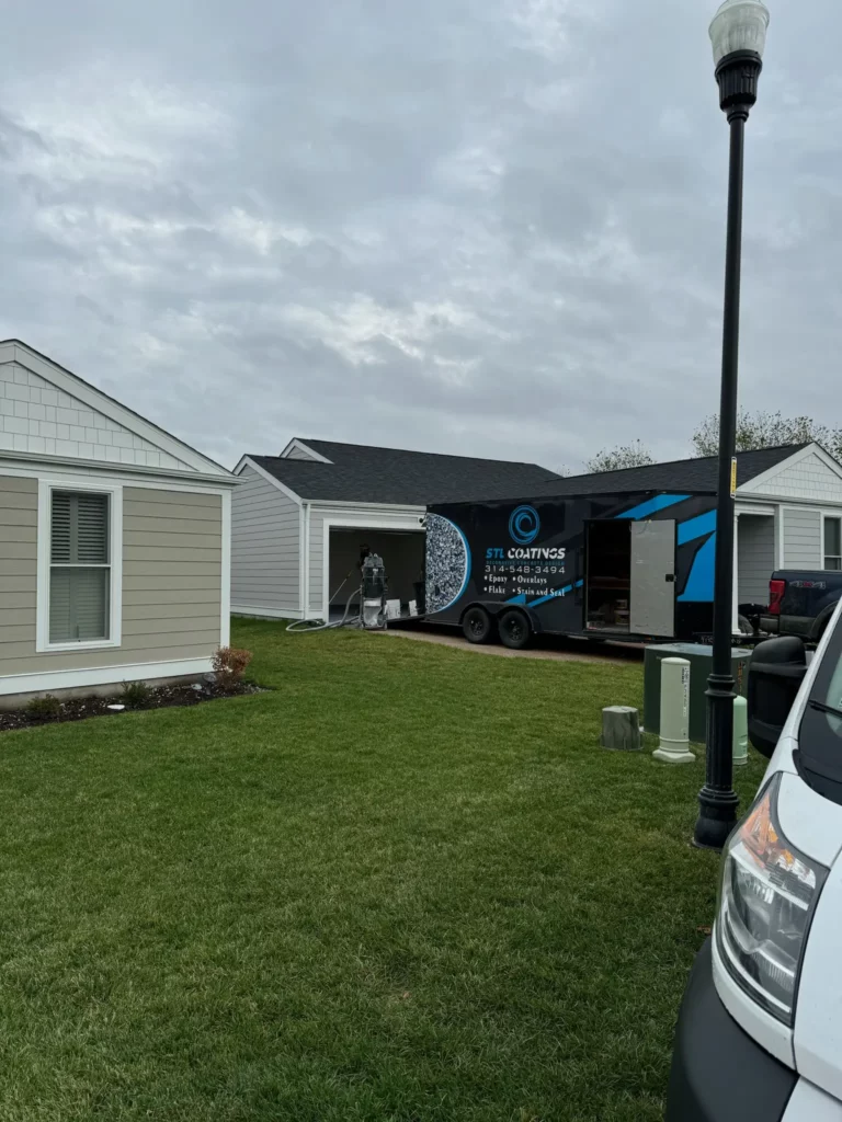 STL Coatings trailer in front of residential epoxy garage