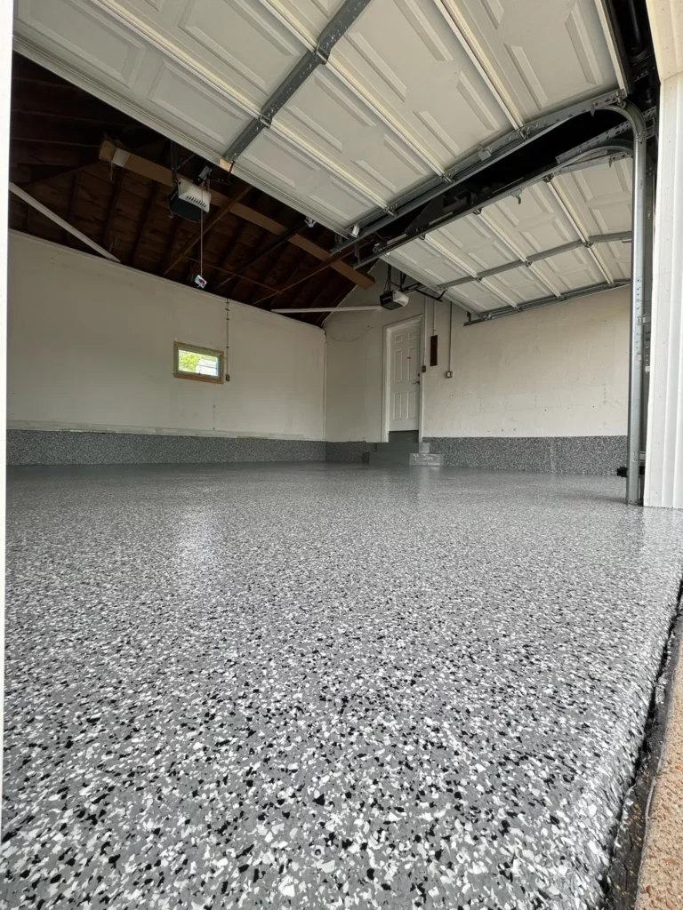 A newly finished garage floor in Lake St. Louis with a light gray epoxy coating for a modern, fresh look.