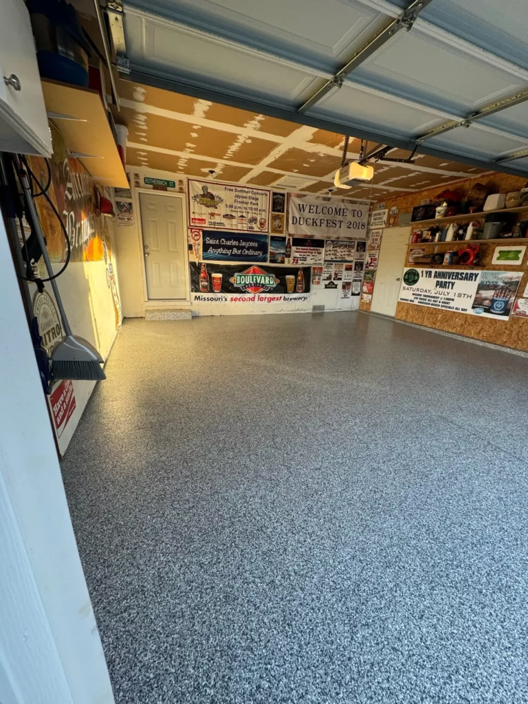 A St. Charles garage featuring a dark gray epoxy floor, creating a bold and modern aesthetic.